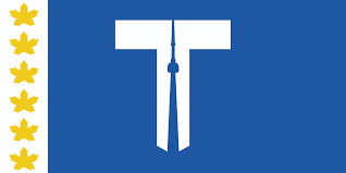 A blue and white flag for the City of Toronto. The shape of a T is in the middle with the CN tower in the middle. 6 golden maple leaves line the left side in a white bar.